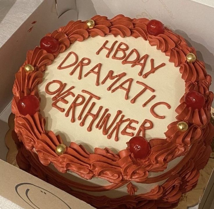 a birthday cake in a box with the words hbday dramatic okehnker written on it