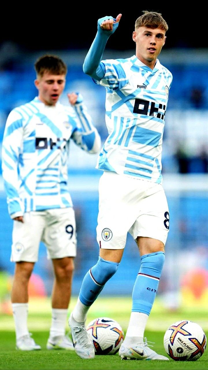 two young men are playing soccer on the field