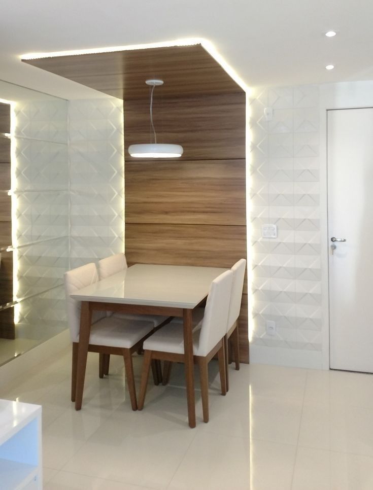 a dining room table and chairs in front of a wall with lights on the side