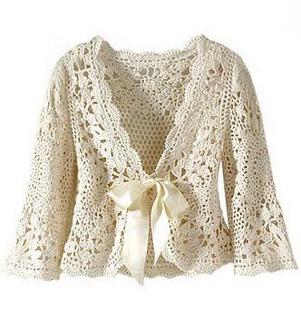 a crocheted cardigan with a bow on the front, and lace detailing