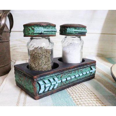 two salt and pepper shakers sitting on top of a table