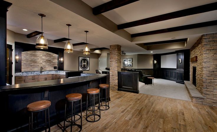 a large home bar with stools in front of it and an open floor plan