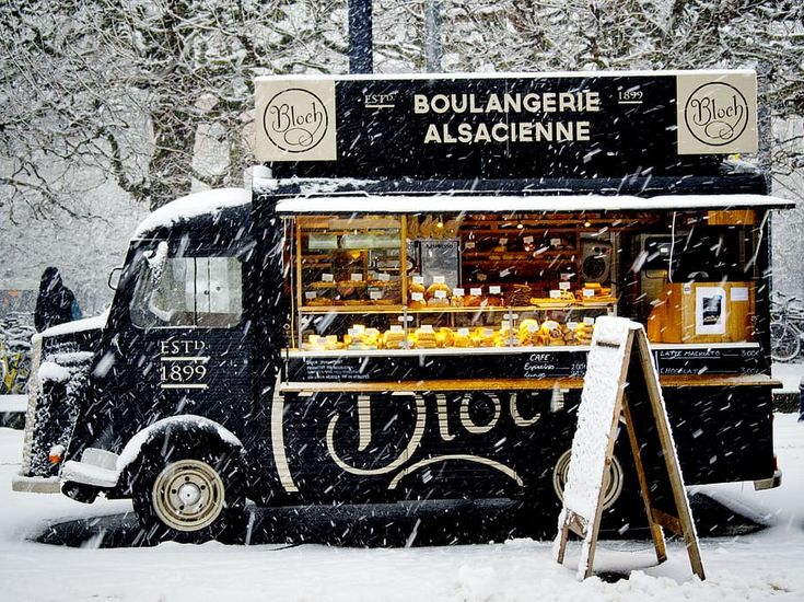 a food truck parked on the side of a road covered in snow with text overlay that reads light reflections 1 support local businesses