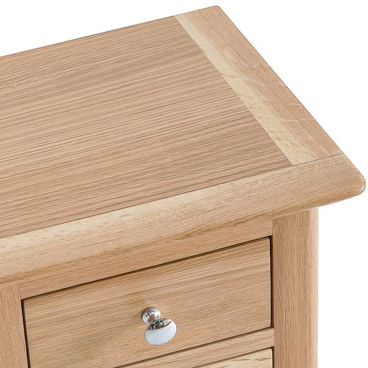 a wooden table with two drawers on one side and an open drawer on the other