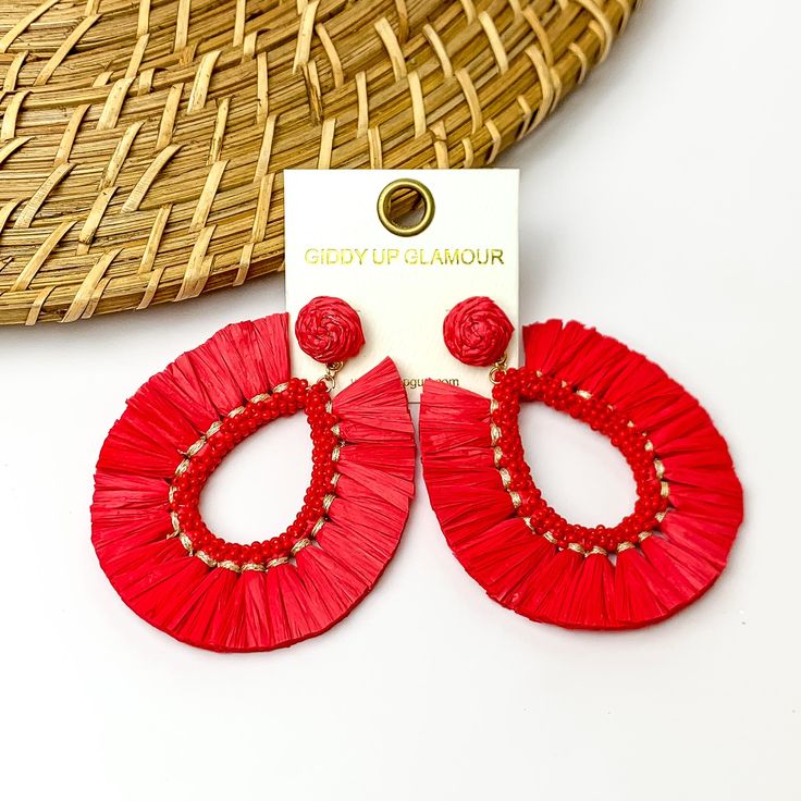 Red fringe open drop hoops with beads on the inside. Pictured on a white background with a wood like decoration in the top left Red Bohemian Jewelry For Vacation, Bohemian Red Jewelry For Vacation, Trendy Red Teardrop Earrings, Red Bohemian Jewelry For Spring, Handmade Red Jewelry For Spring, Red Earrings For Summer Party, Summer Teardrop Earrings, Spring Vacation Dangle Jewelry, Red Summer Party Jewelry