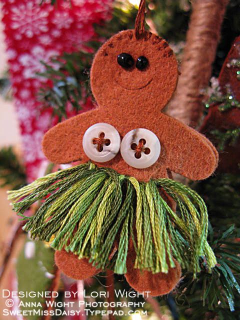 an ornament hanging from a christmas tree decorated with buttons and grass skirtes