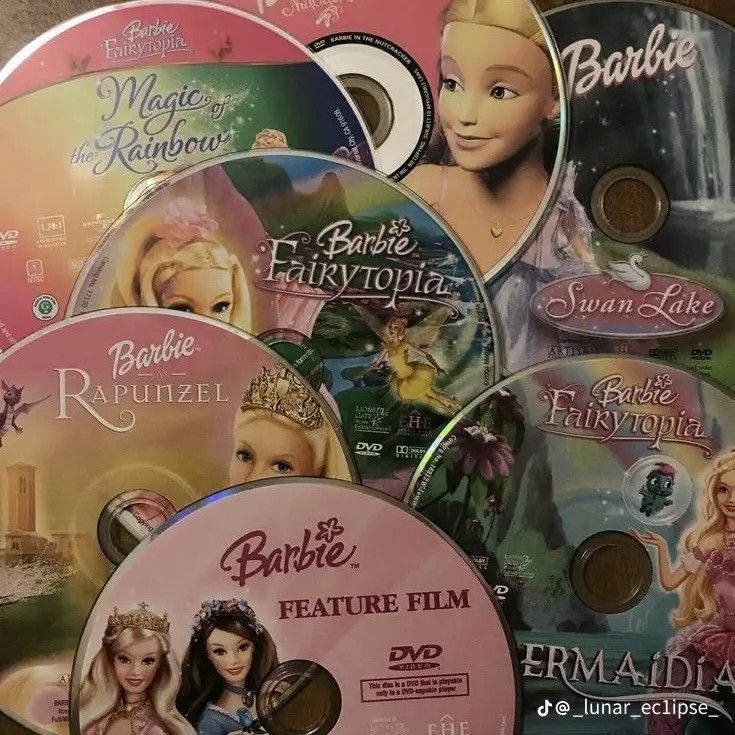 barbie dvd's are stacked on top of each other