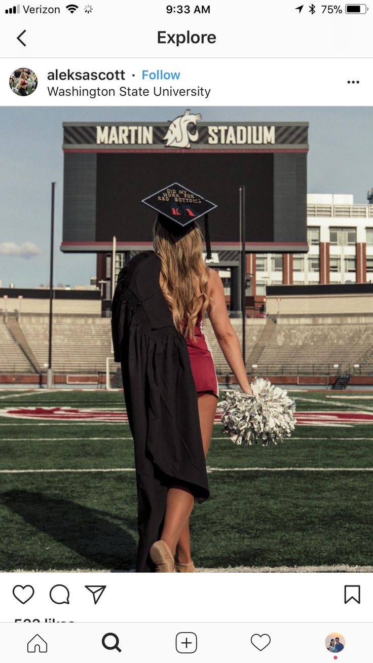 a woman in a graduation cap and gown walking across the field with her hand on her hip