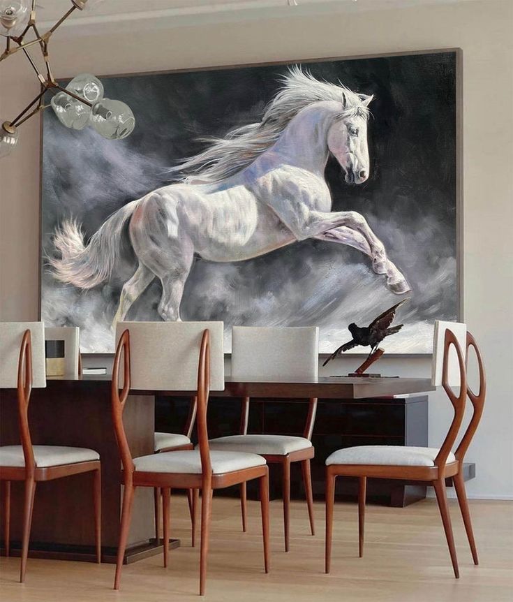 a painting of a white horse is on the wall above a dining room table and chairs