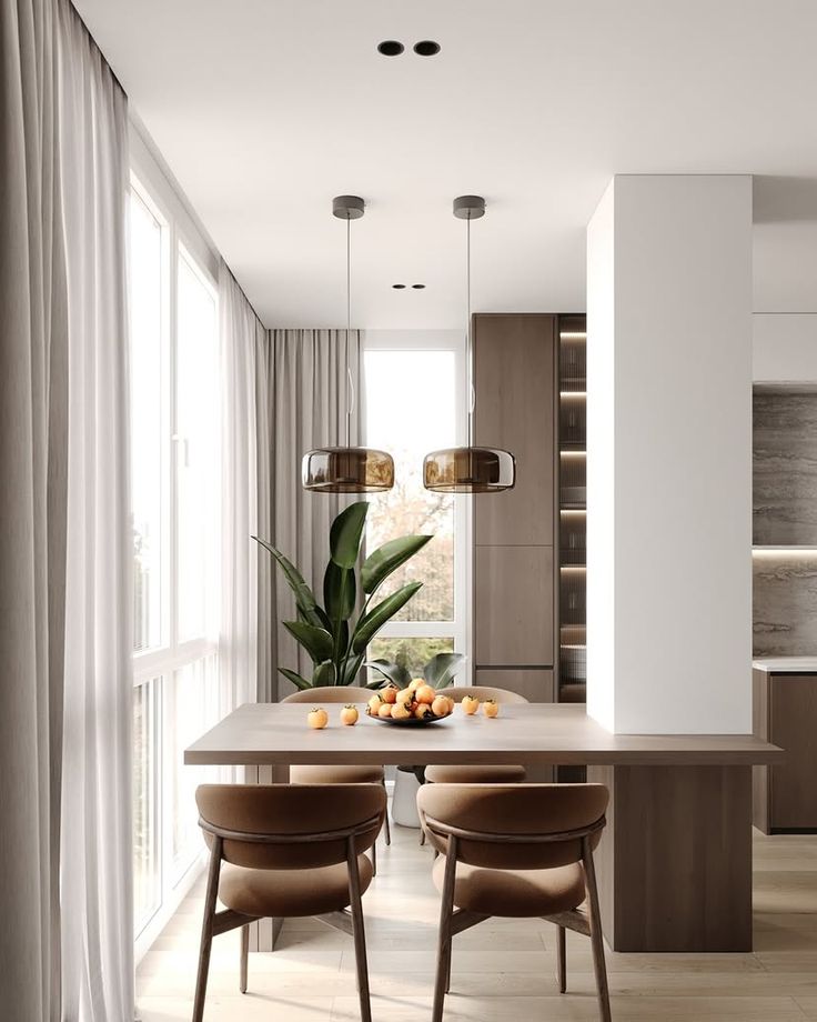 a dining room table and chairs in front of a window