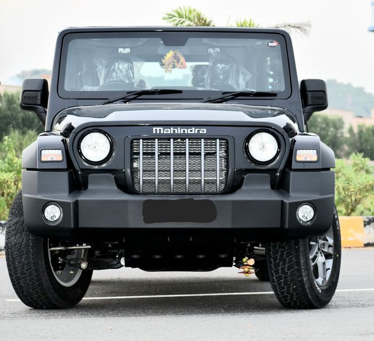 a black jeep parked in a parking lot