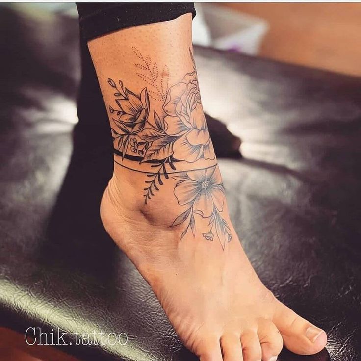 a woman's foot with a flower tattoo on her left ankle and the bottom part of her leg