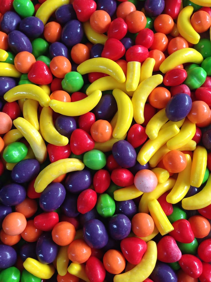 many different colored candy candies and bananas