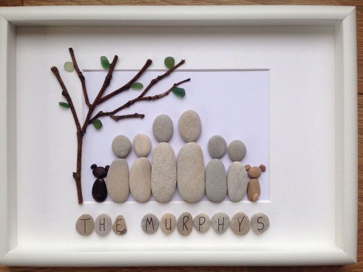 a white frame with some rocks and a small tree on the side that says the murphys