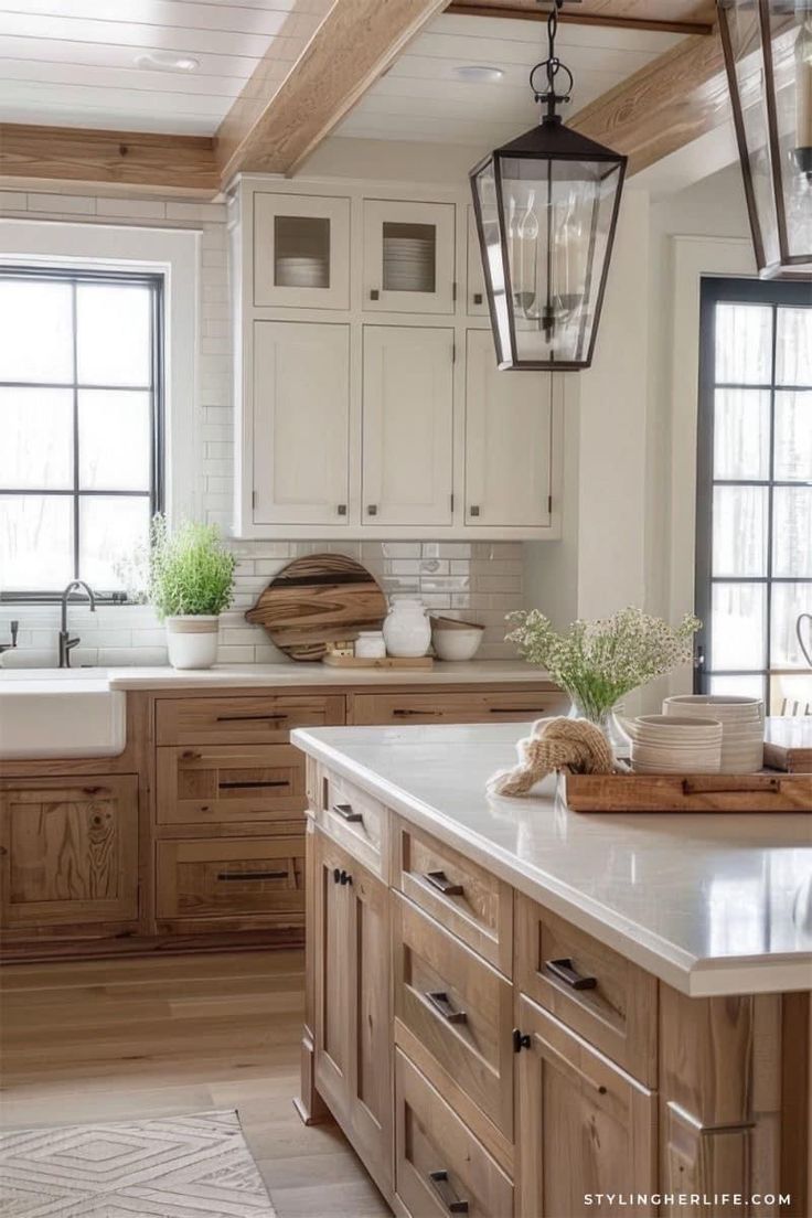 a kitchen filled with lots of wooden cabinets and white counter tops next to a window