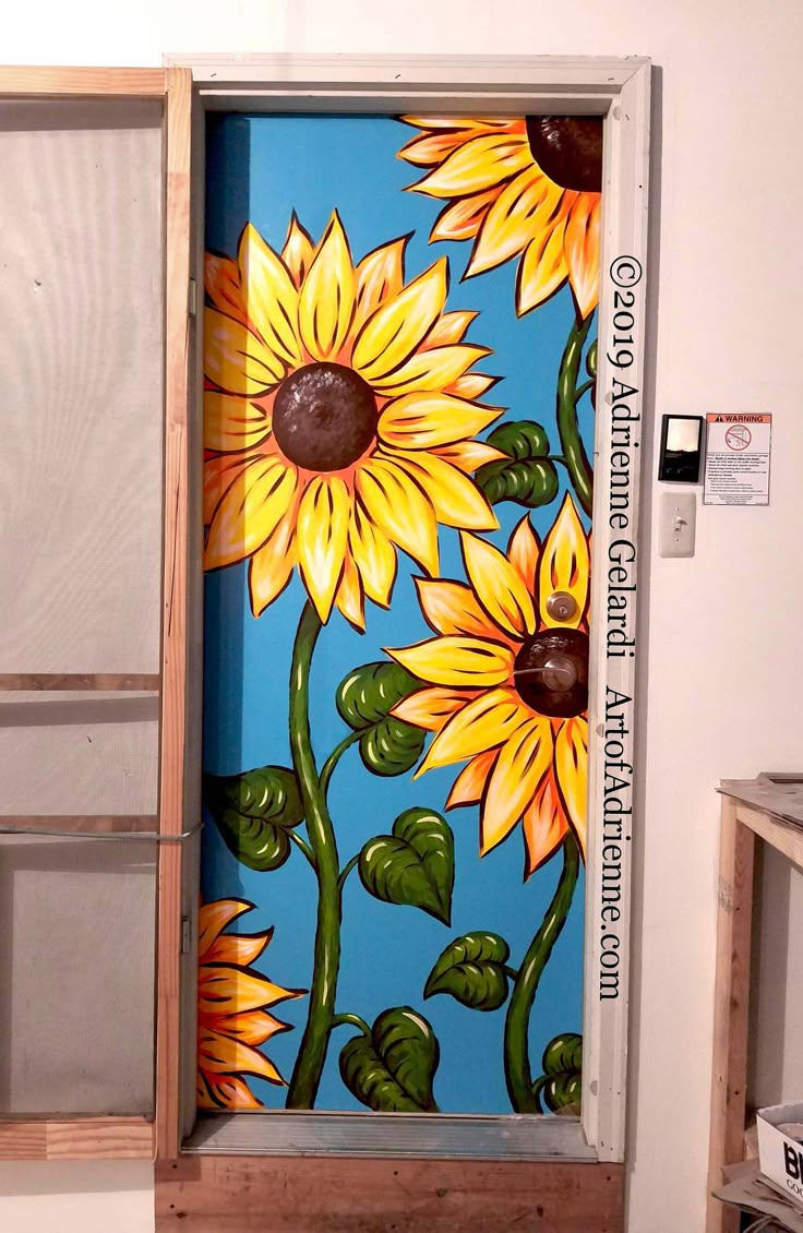 an open door with sunflowers painted on it