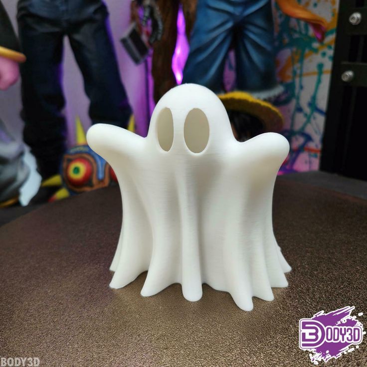 a white ghost figurine sitting on top of a table