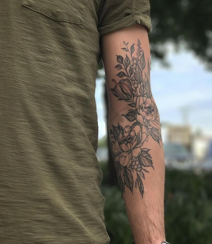 a man with a flower tattoo on his arm