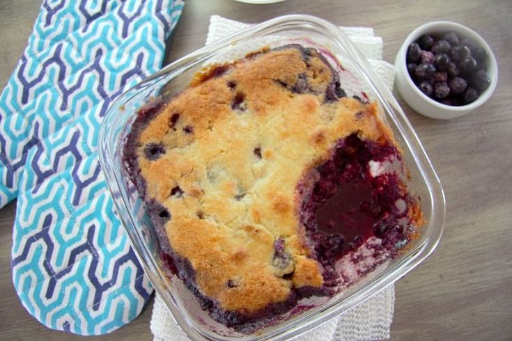 a blueberry cobbler in a plastic container on a table