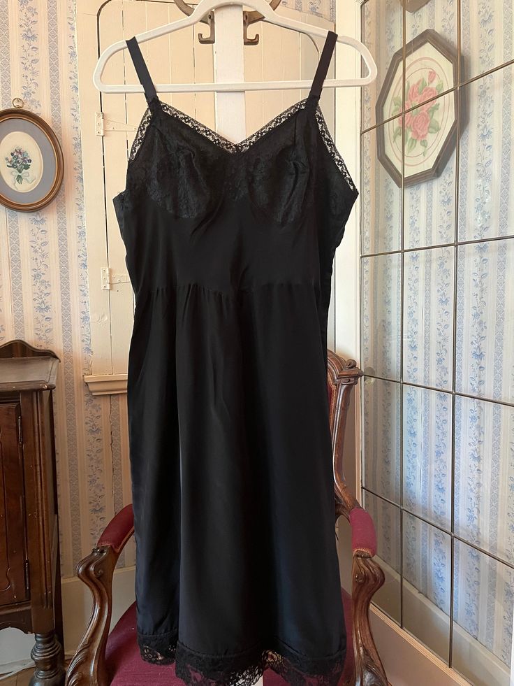 This is a beautiful, medium weight, satiny feeling polyester black slip or slip dress, trimmed with black lace on the bust and bottom edge. The measurements, taken with the slip lying flat, are: armpit to armpit/bust, 19 inches; waist, 17 inches; length, 41 inches (from top of strap); bottom edge, 28 inches. In very good condition. Diy Bra Pattern, Diy Bra, Lingerie Slip Dress, Lingerie Slip, Bra Pattern, Black Lace Trim, Lace Slip Dress, Lace Slip, Clothes To Buy