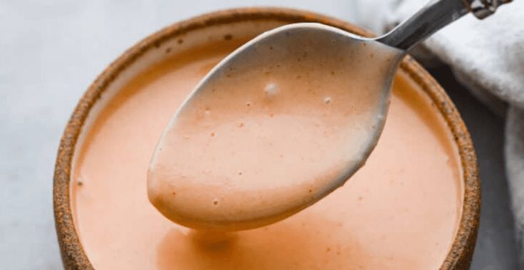 a spoon in a bowl filled with liquid