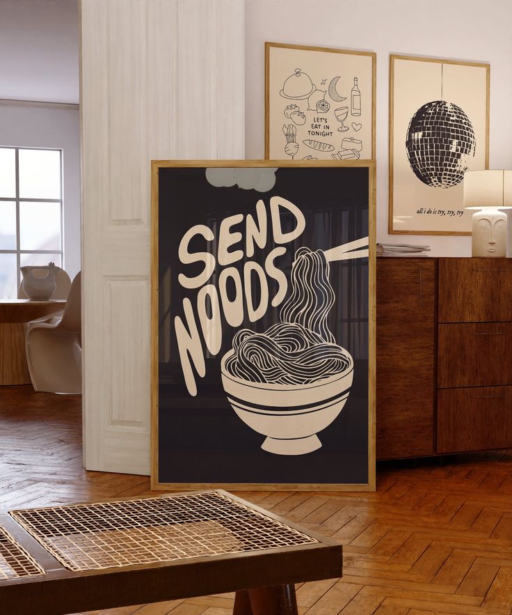 there is a sign that says send noodles in front of a wooden table and chairs