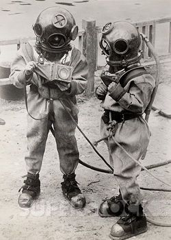 two young boys in diving suits and gas masks