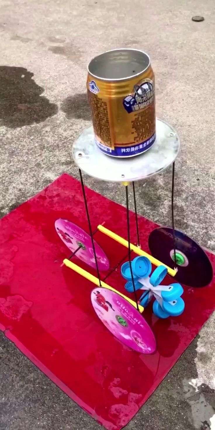 a red rug with some toys on it and a can sitting on top of it