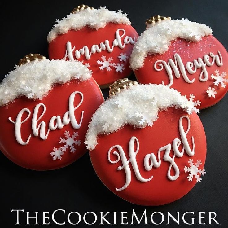 three decorated christmas cookies with white frosting on them