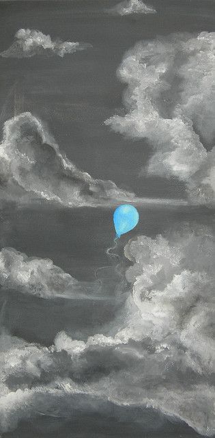 a blue balloon floating in the middle of some white clouds on a black and gray sky