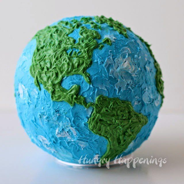 a cake shaped like the earth with green and blue icing