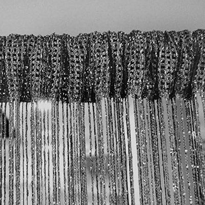 black and white photograph of curtains with snow on them