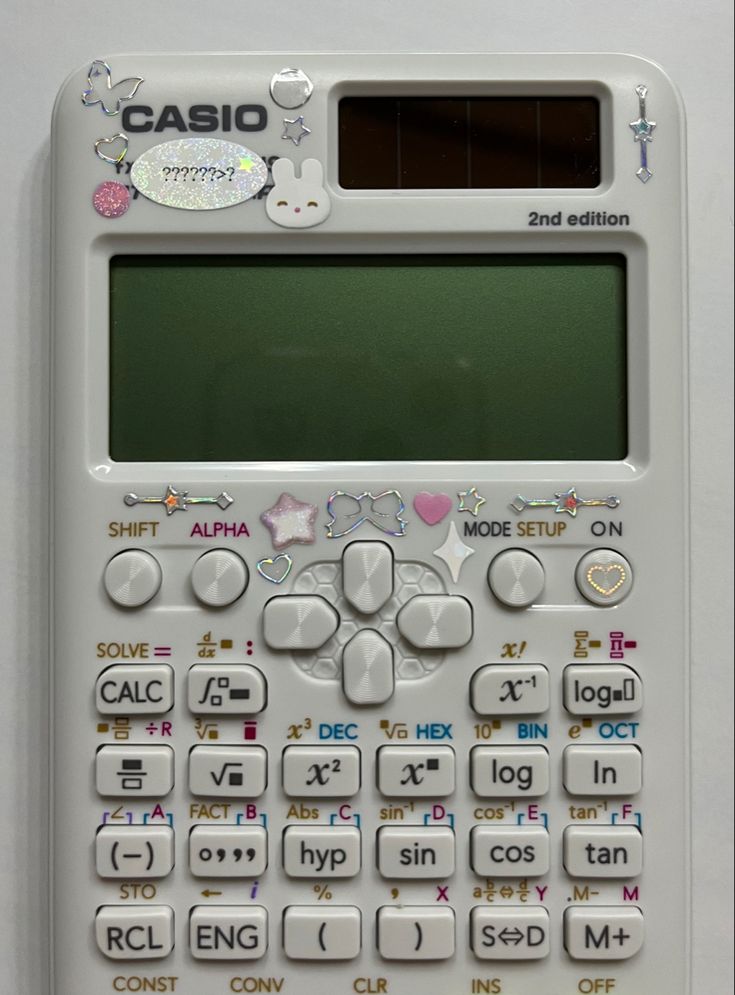 an old calculator with stickers all over it's face and numbers