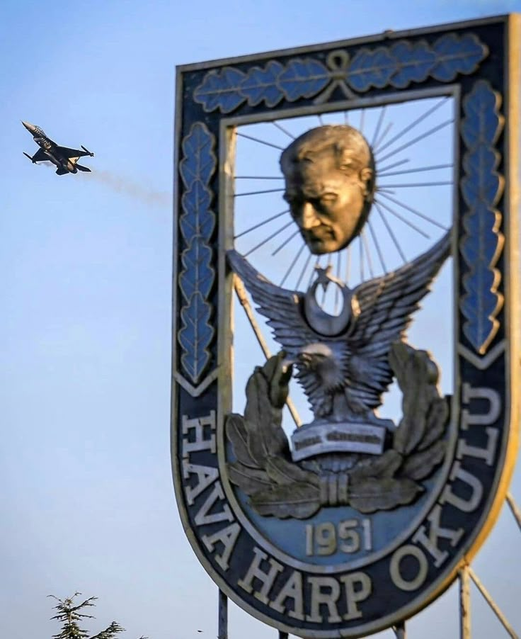 an air force sign with a jet flying in the background