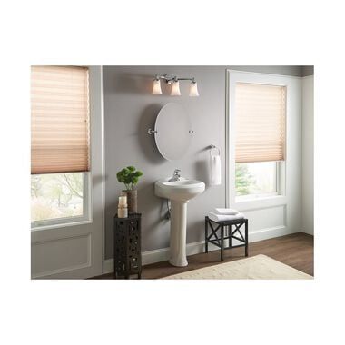 a white sink sitting next to a window with blinds on the side of it and a mirror above it