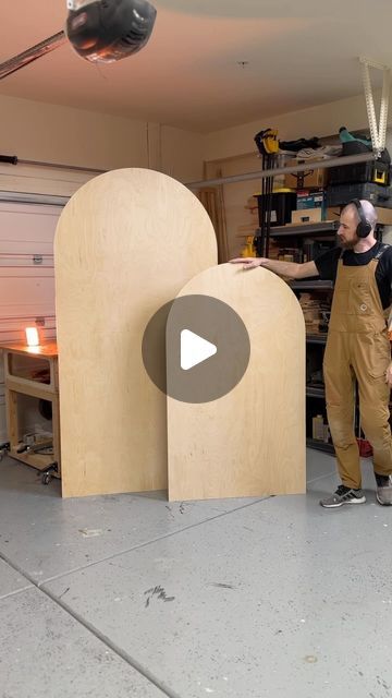 two men are working on wooden sculptures in a garage