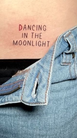 a woman's stomach with the words dancing in the moonlight written on her belly