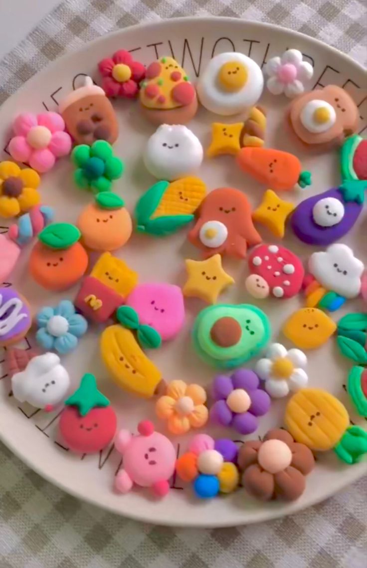 a white plate topped with lots of different types of toy buttons on top of a checkered table cloth