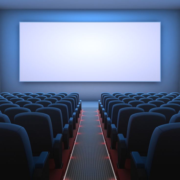 an empty theater with rows of seats facing the screen