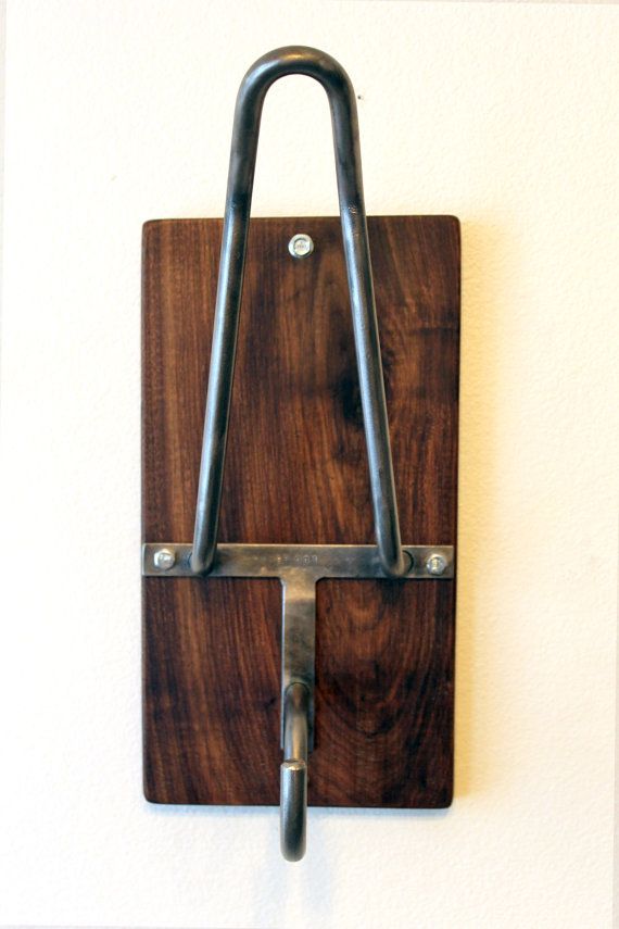 a wooden and metal hook on the wall