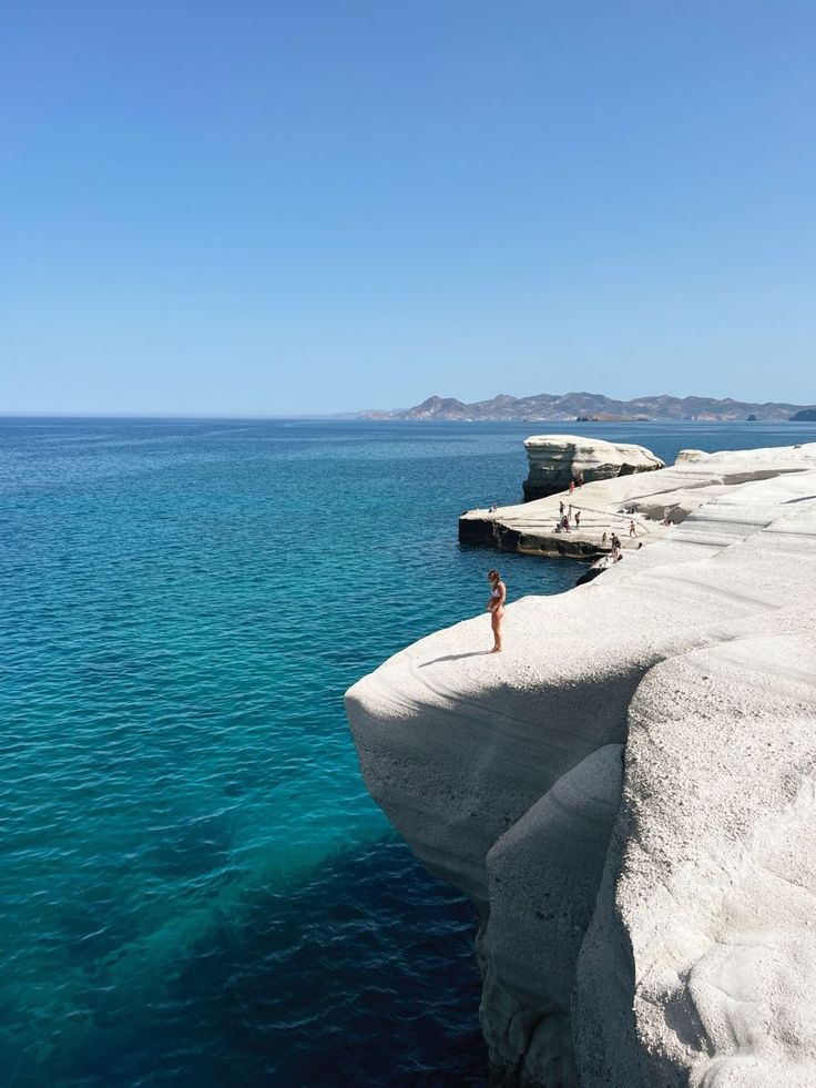 a person standing on the edge of a cliff