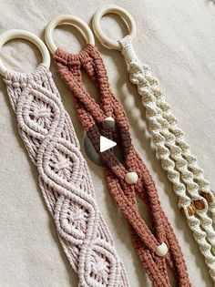 three crocheted key fobs are laying on a white surface with beads