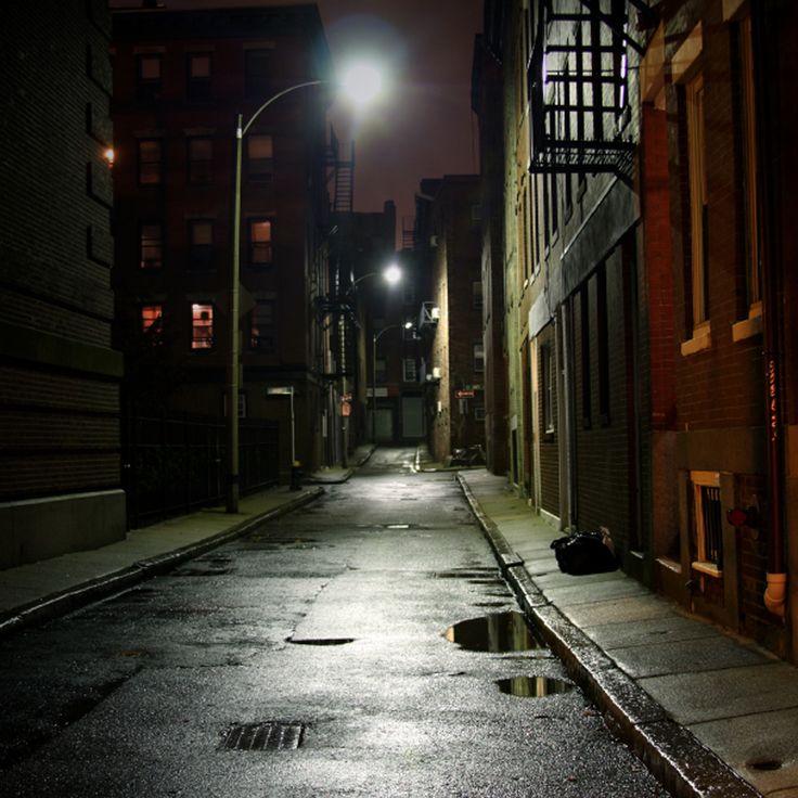 an empty city street at night with no one on it