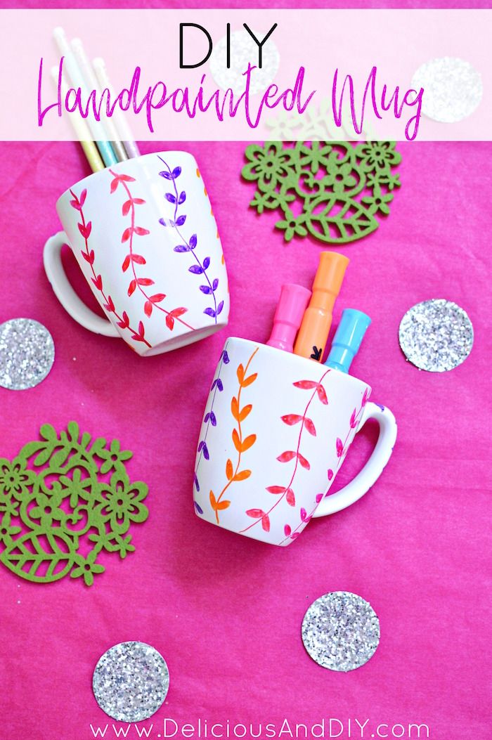 diy handpainted mugs with markers, pens and paper flowers on a pink background