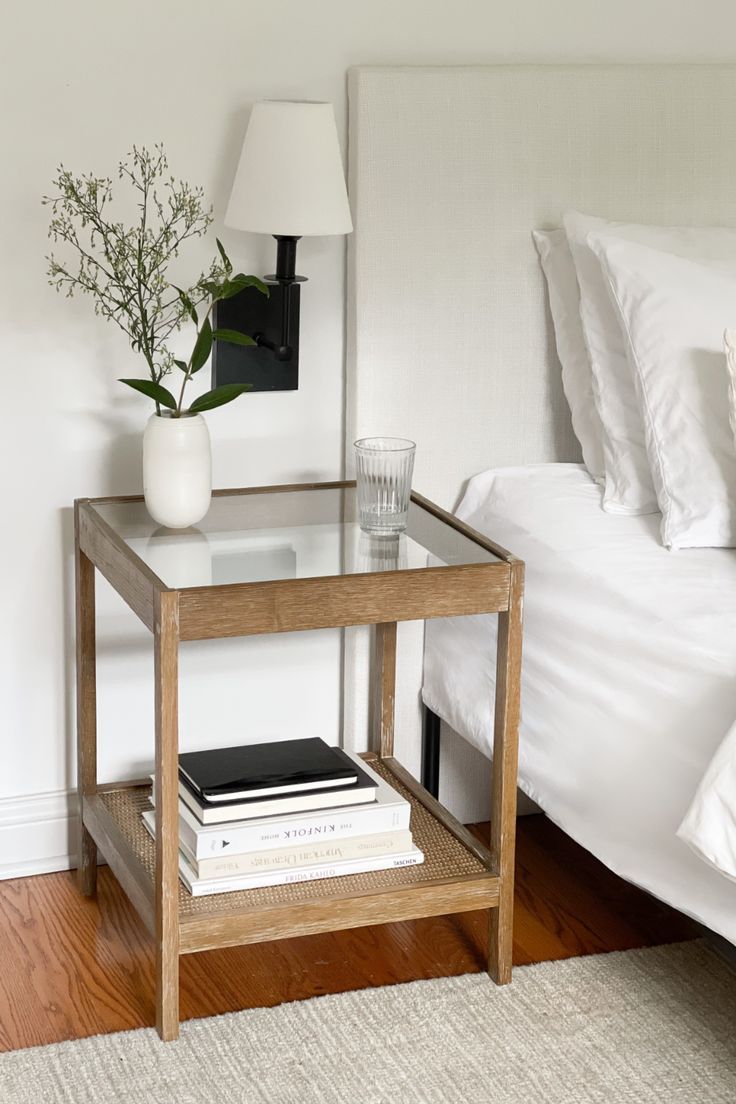 Meet Hayes. Organic, open, and airy. The clear tempered glass top and open design of this side table add visual space to any room and make it a great solution for small spaces. The solid wood frame with a light brown, wire-brushed finish and rattan shelf on the bottom add a natural touch and give you a chic boho feel. #bedroomdecor #bedroominspiration #sidetabledecor #sidetable #minimalbedroom Glass Top Bedside Table, Minimal Side Table, Glass Bedside Table, Glass Nightstand, Nathan James, Glass Top End Tables, Rattan Side Table, Wooden Bedside Table, Side Tables Bedroom