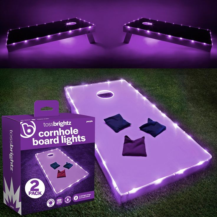 two light up bean bag tossers in the grass with purple and white lights on them