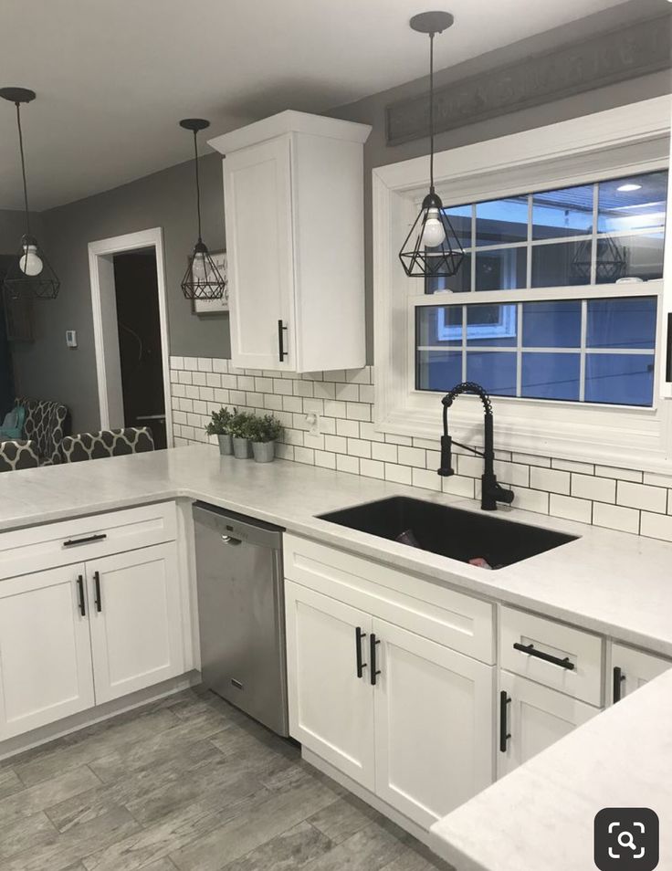 the kitchen is clean and ready to be used for cooking or baking, with all white cabinets