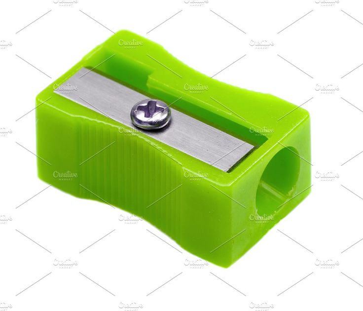 a green sharpener with a metal blade on it's side and a white background