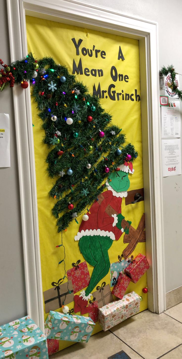 the grinch door is decorated with christmas decorations and presents for children to put on