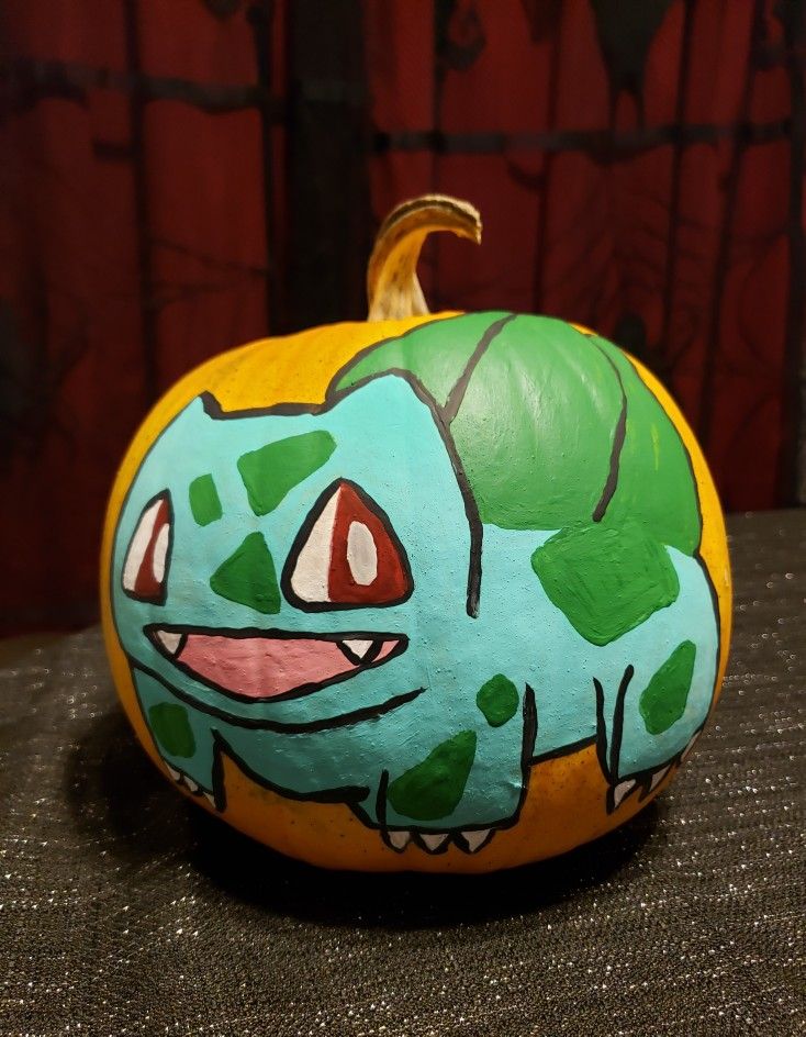 a painted pumpkin sitting on top of a table